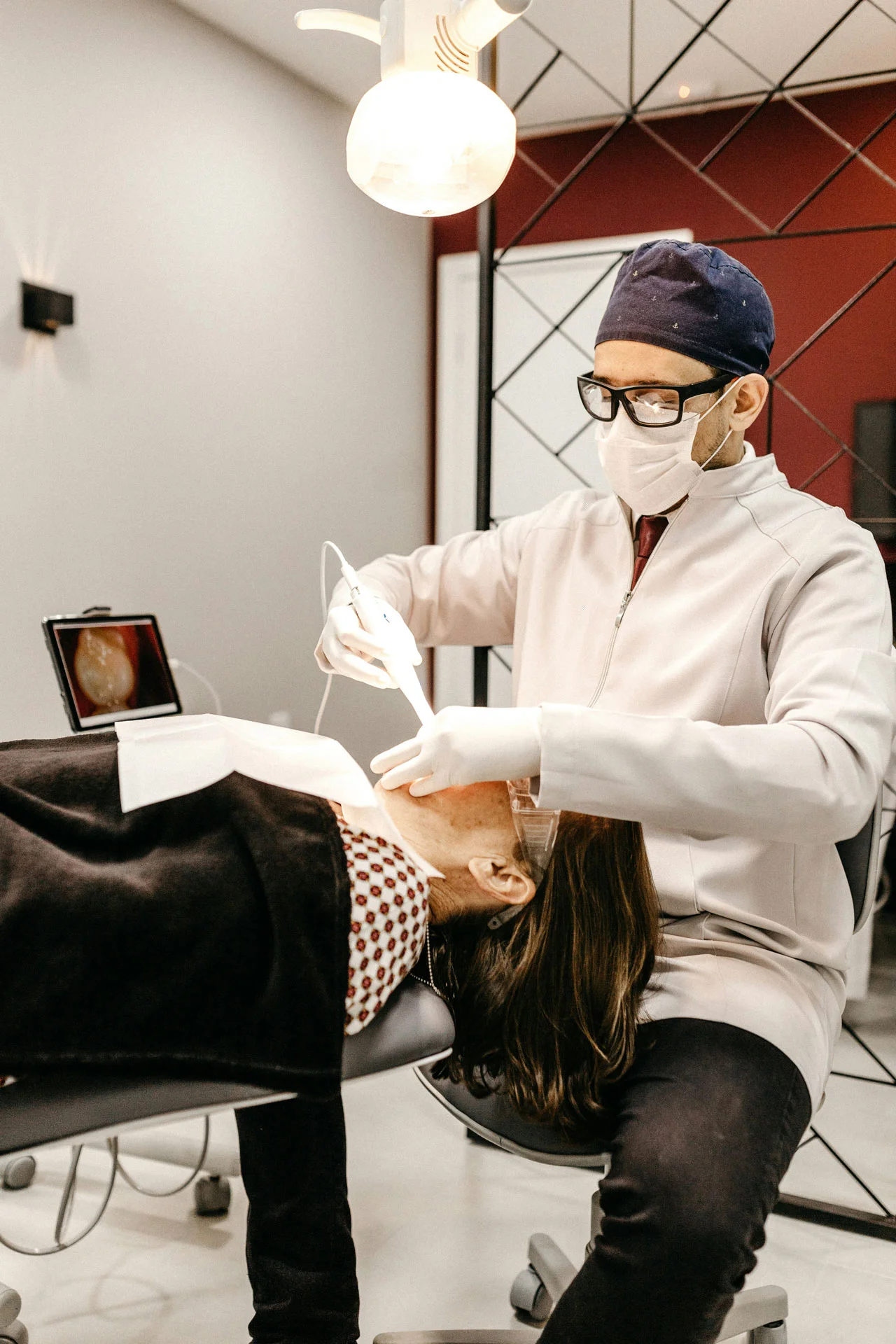 Dentistry-ultra-smile-clinic-4 Dentist examining a patient's teeth at Ultra Smile Clinic